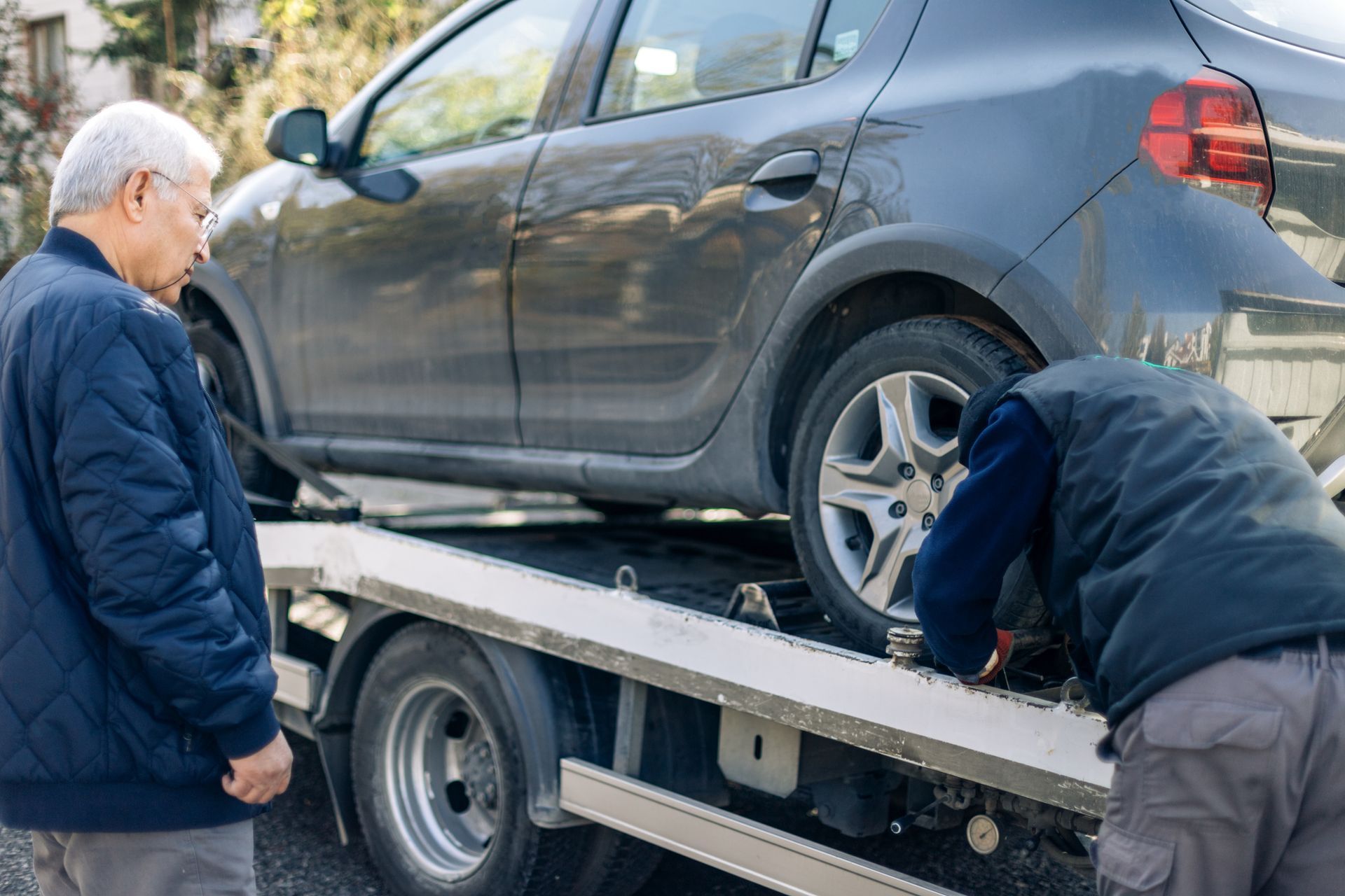Man Securing Car In Tow Truck - Long Beach, MS - ABC Towing