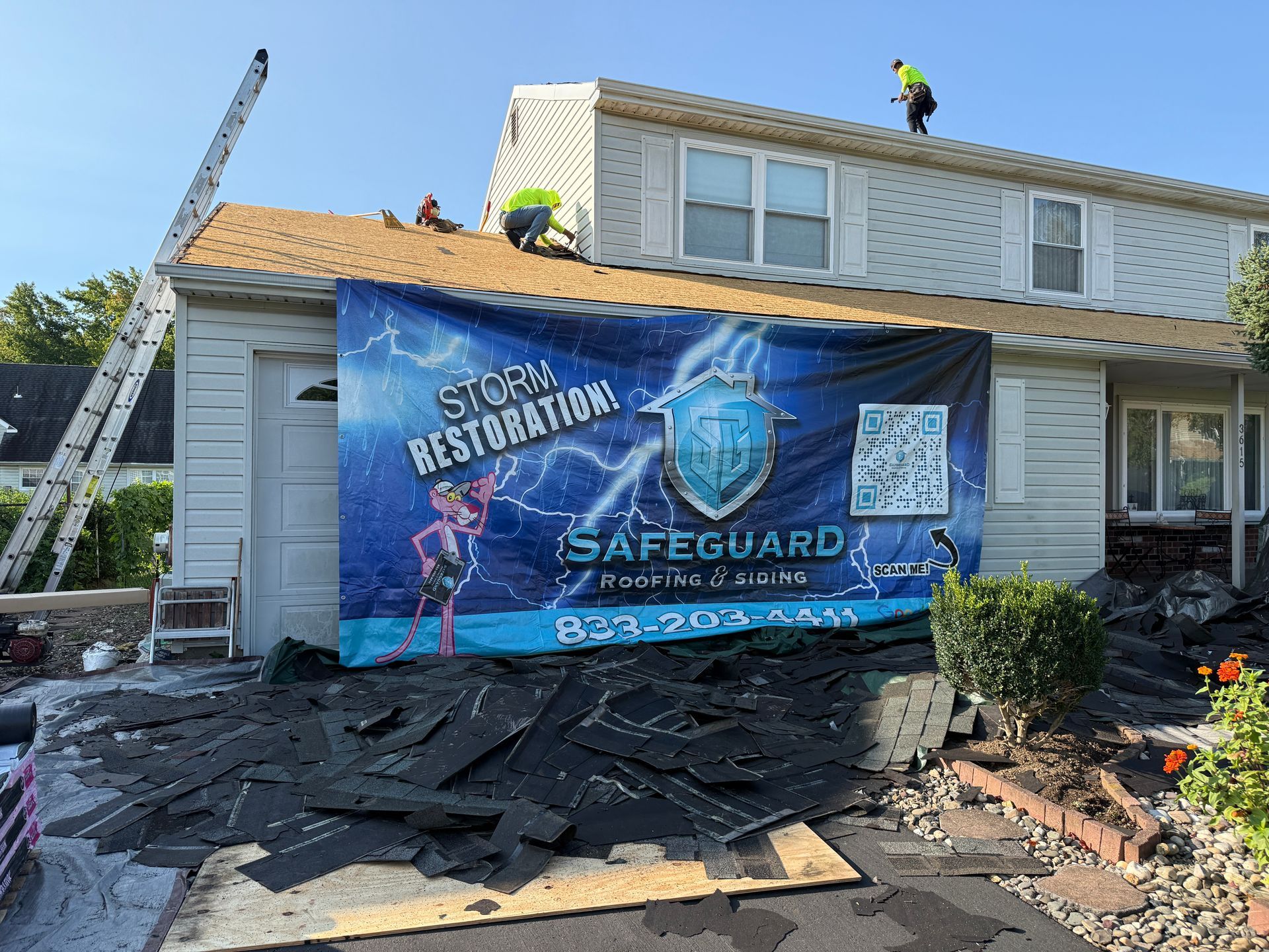 Roofers working on a house, banner reads 
