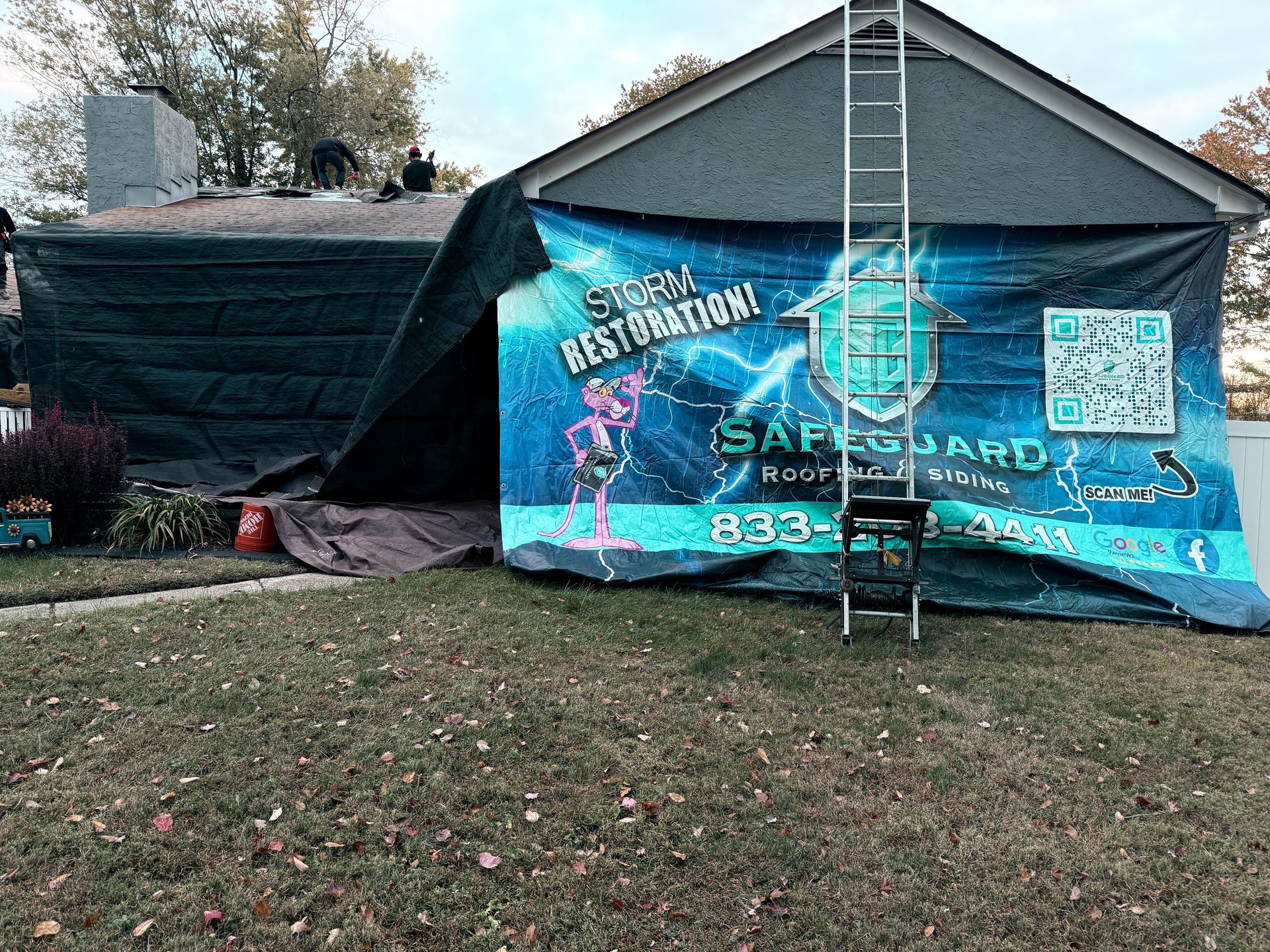 House under construction; tarp covers roof with 