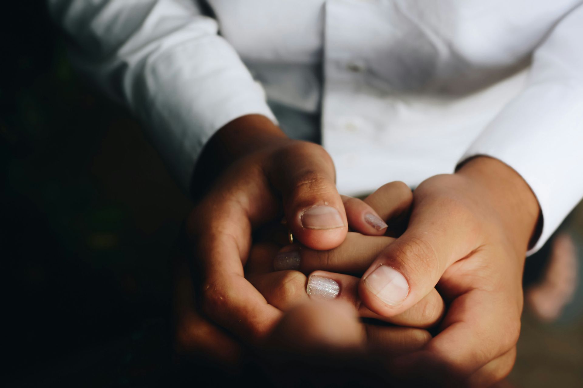 Two people holding hands as one shares news of an unplanned pregnancy