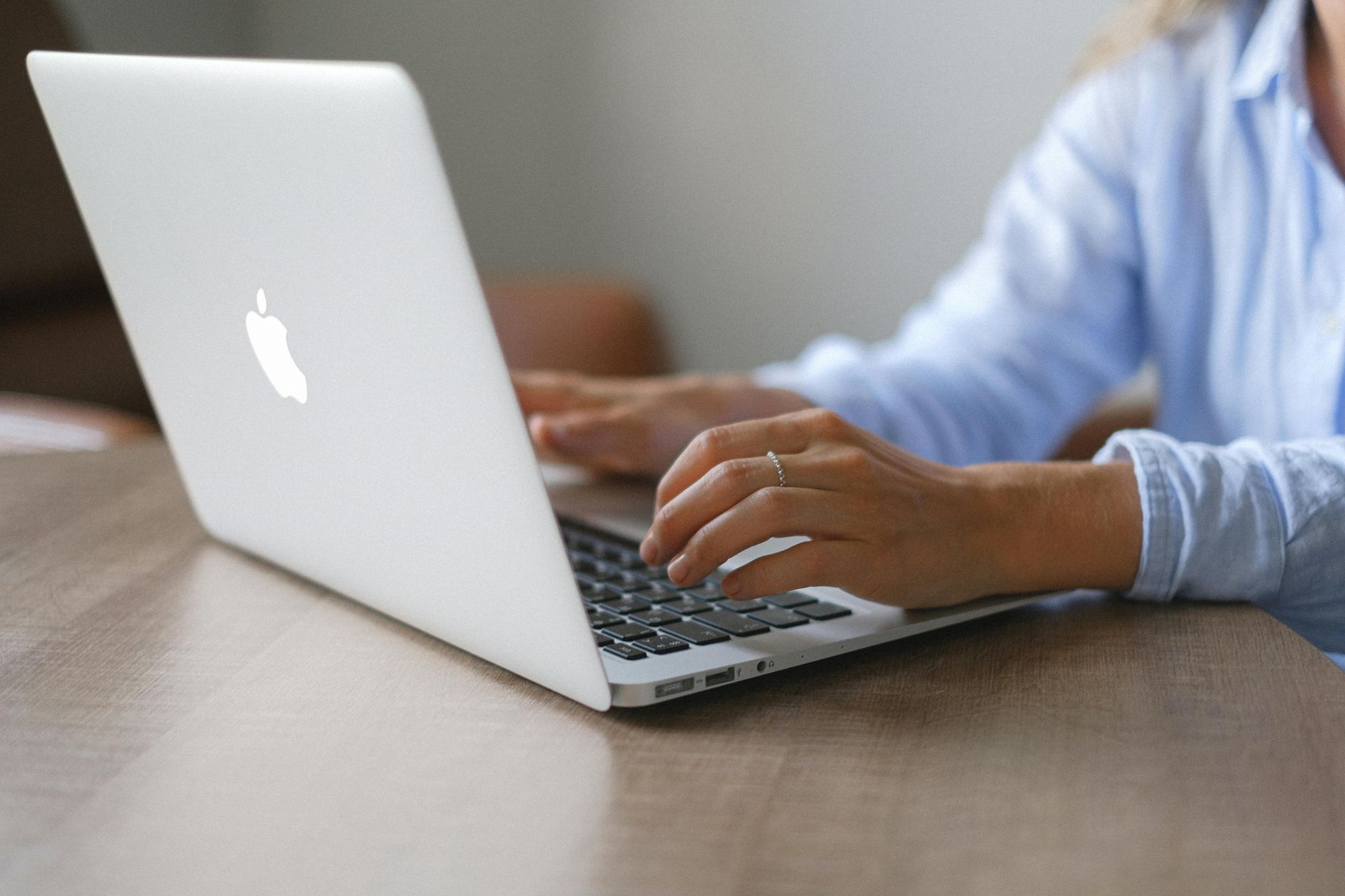 woman types on a laptop to discover answers to unplanned pregnancy questions