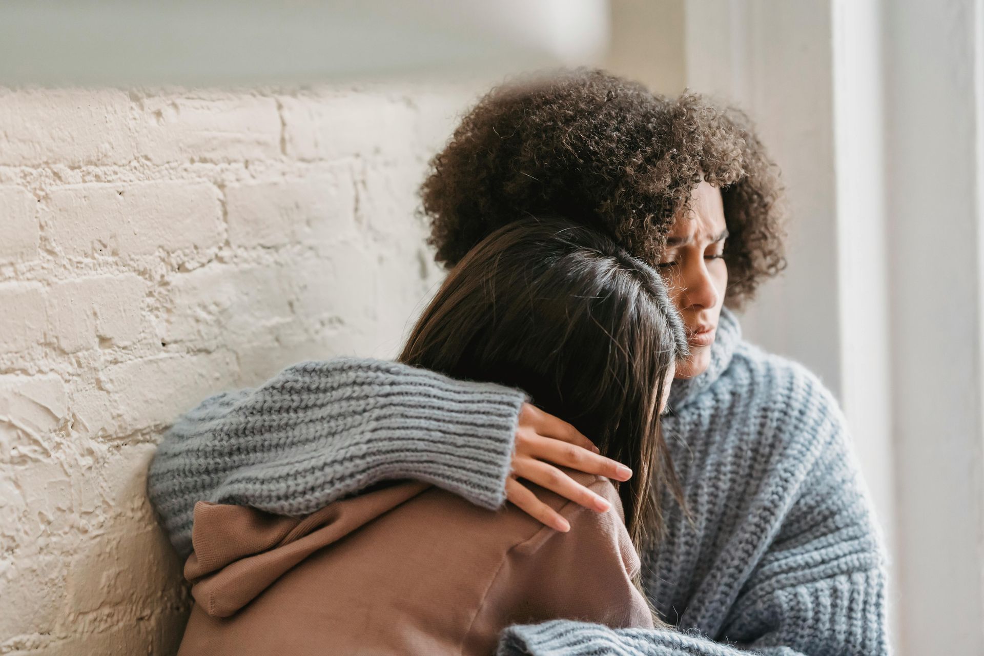 Woman comforting sad woman