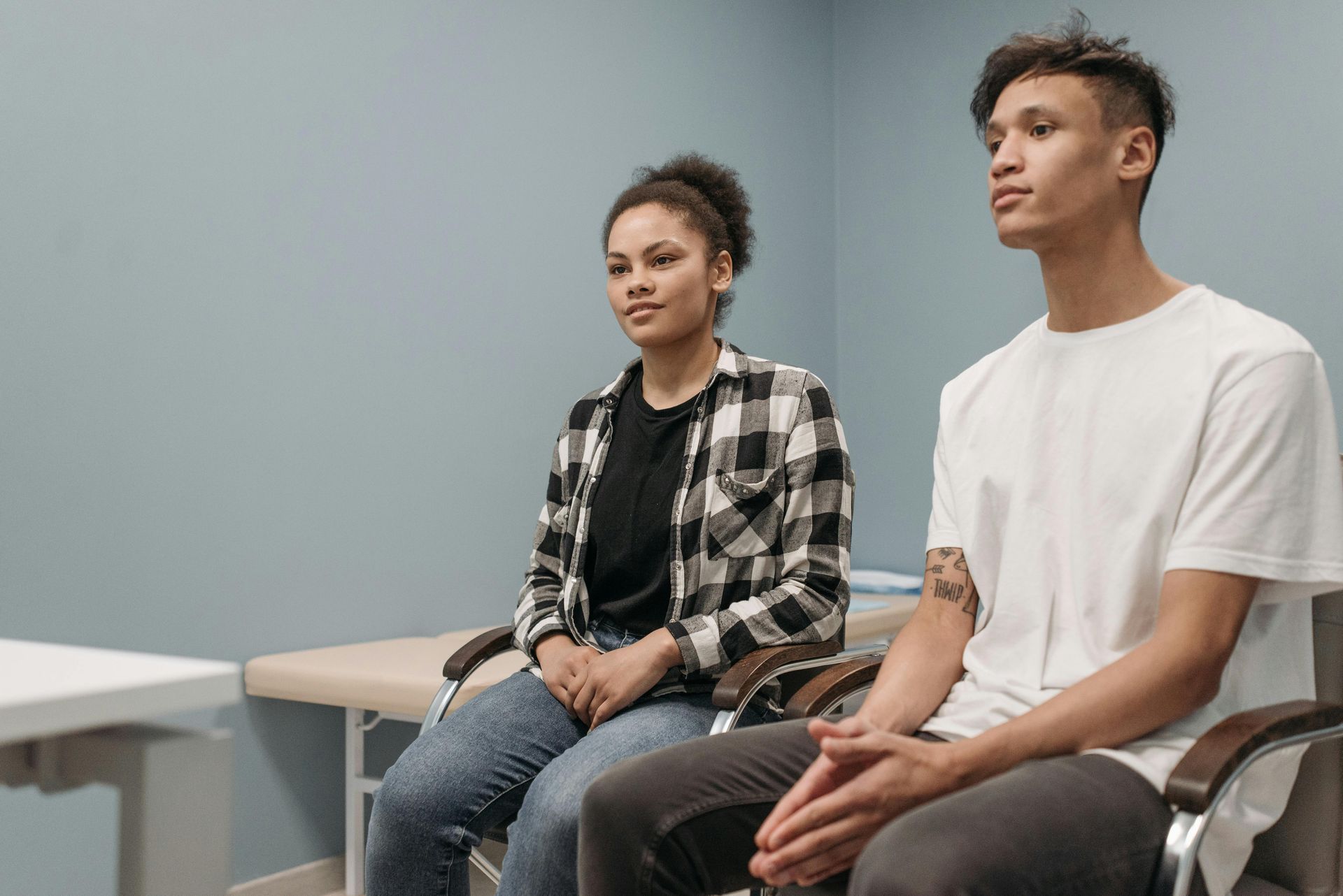 a young couple waits for a doctor for unexpected pregnancy