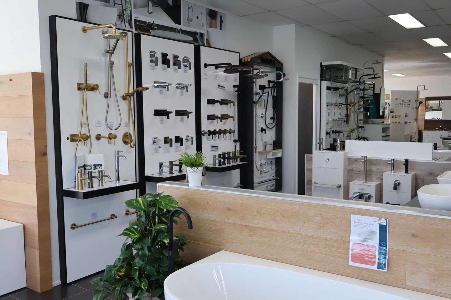 A bathroom showroom filled with lots of faucets and sinks.