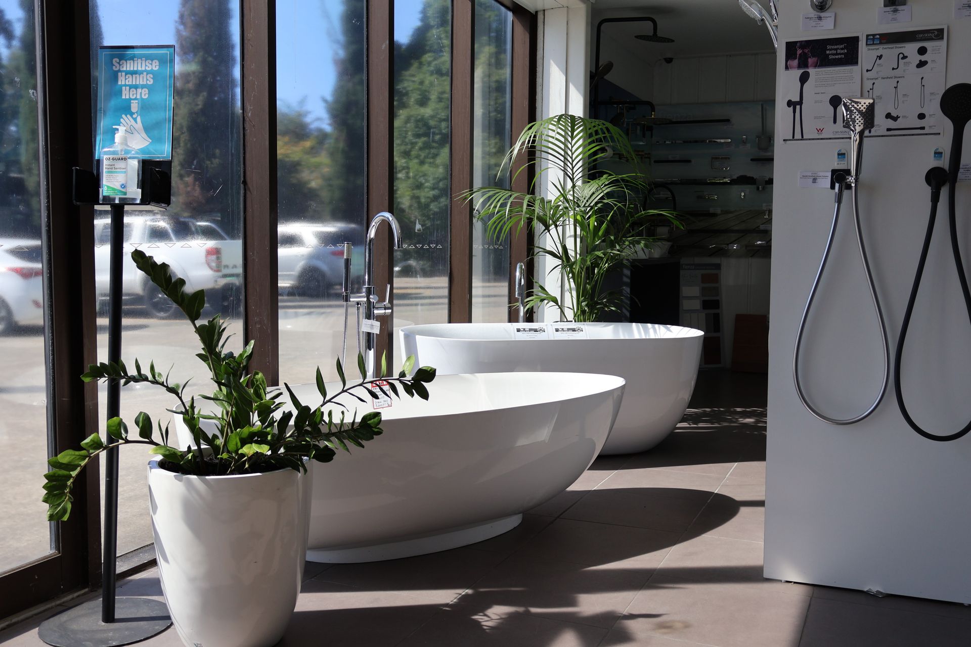 A bathroom with two bathtubs and a potted plant.