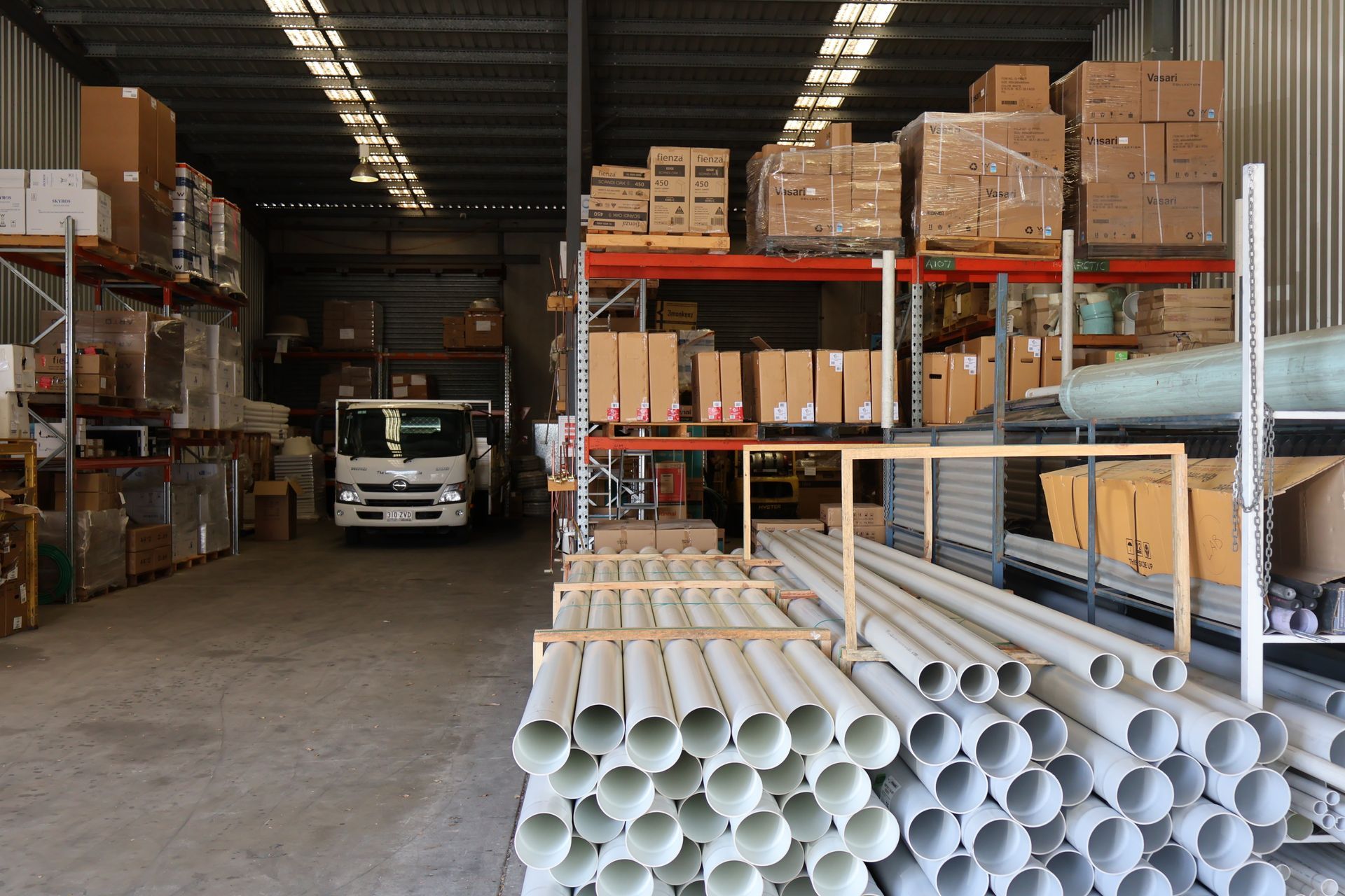 A warehouse filled with lots of pipes and boxes.