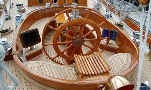 Teak helm by Teakdecking Systems, showcasing precision craftsmanship and elegant design for a luxurious marine experience
