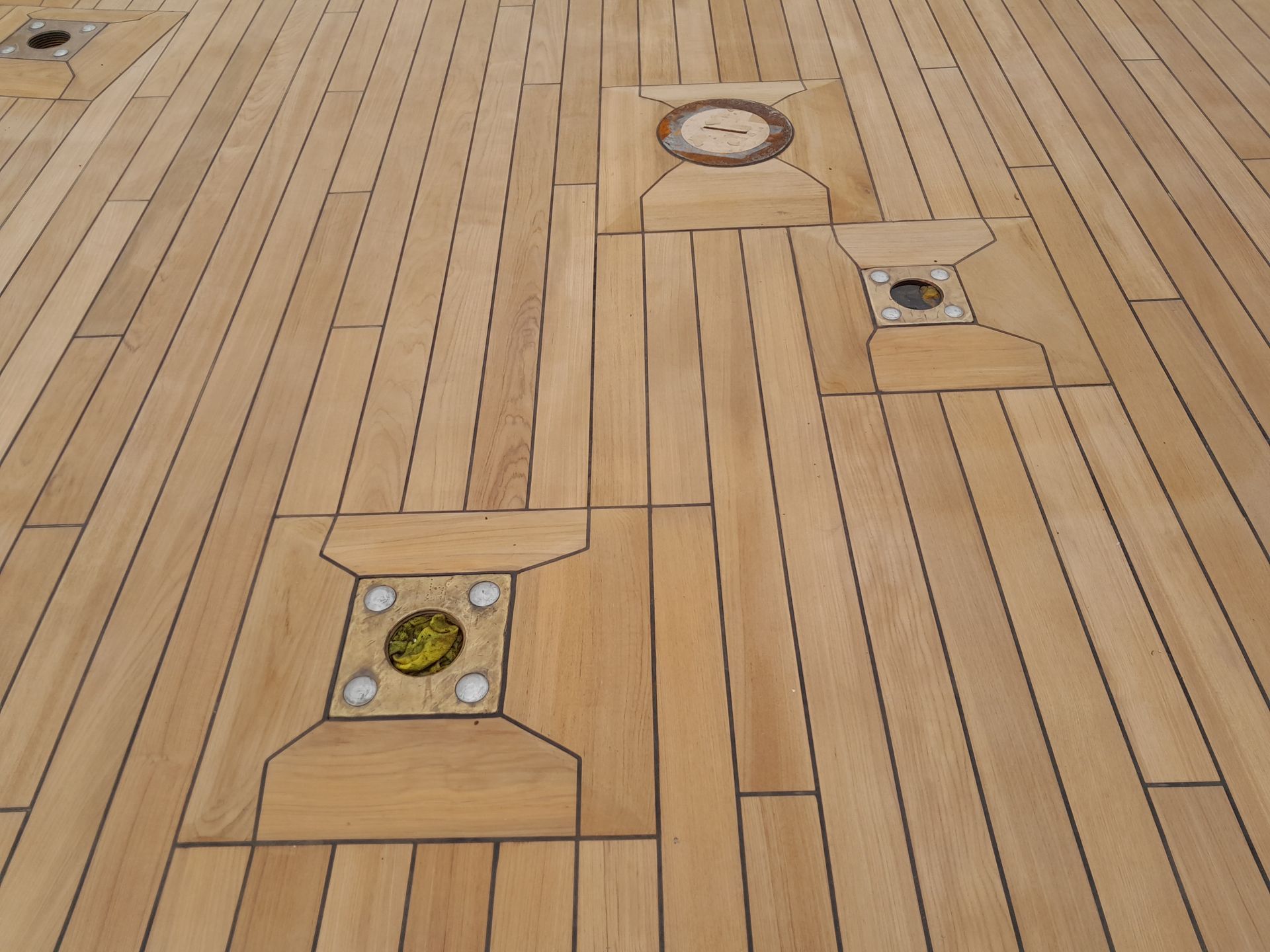 Teak deck with an artistic pattern, highlighting intricate design and expert craftsmanship in marine decking