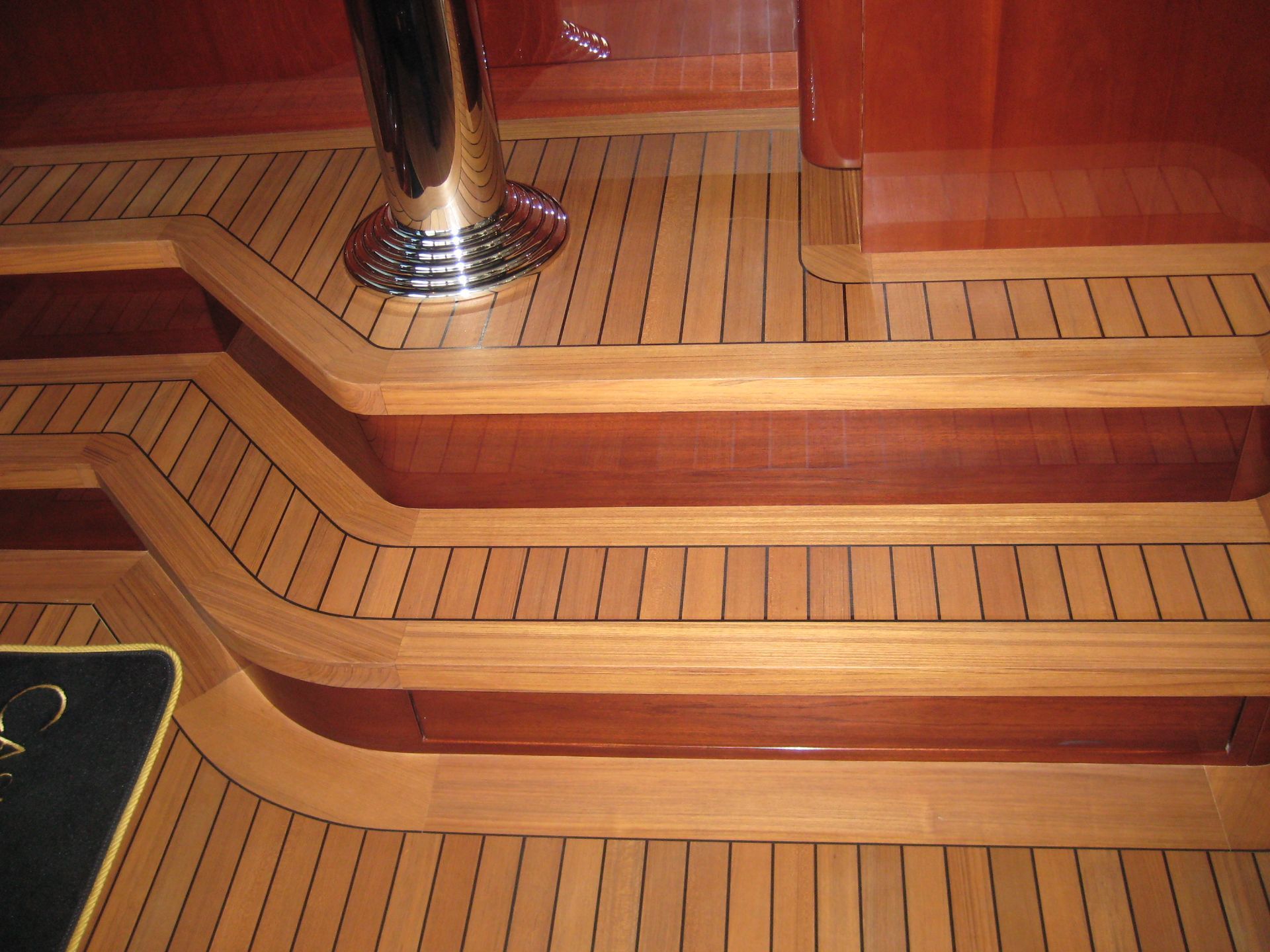 Luxurious yacht interior featuring diverse woods and high gloss finishes, highlighting elegant design and craftsmanship