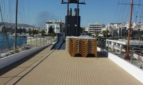Teakdecking Systems loading composite decking onto a deck for installation, showcasing precision and craftsmanship