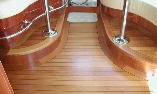 Decorative teak surrounding interior boat deck hardware, showcasing intricate craftsmanship and elegant marine design