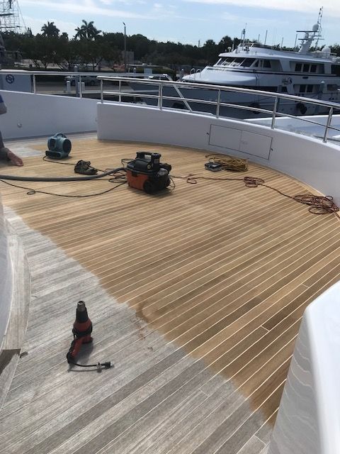 Teakdecking Systems sanding out the Anna Star's teak deck, renewing its surface and ensuring long-lasting durability