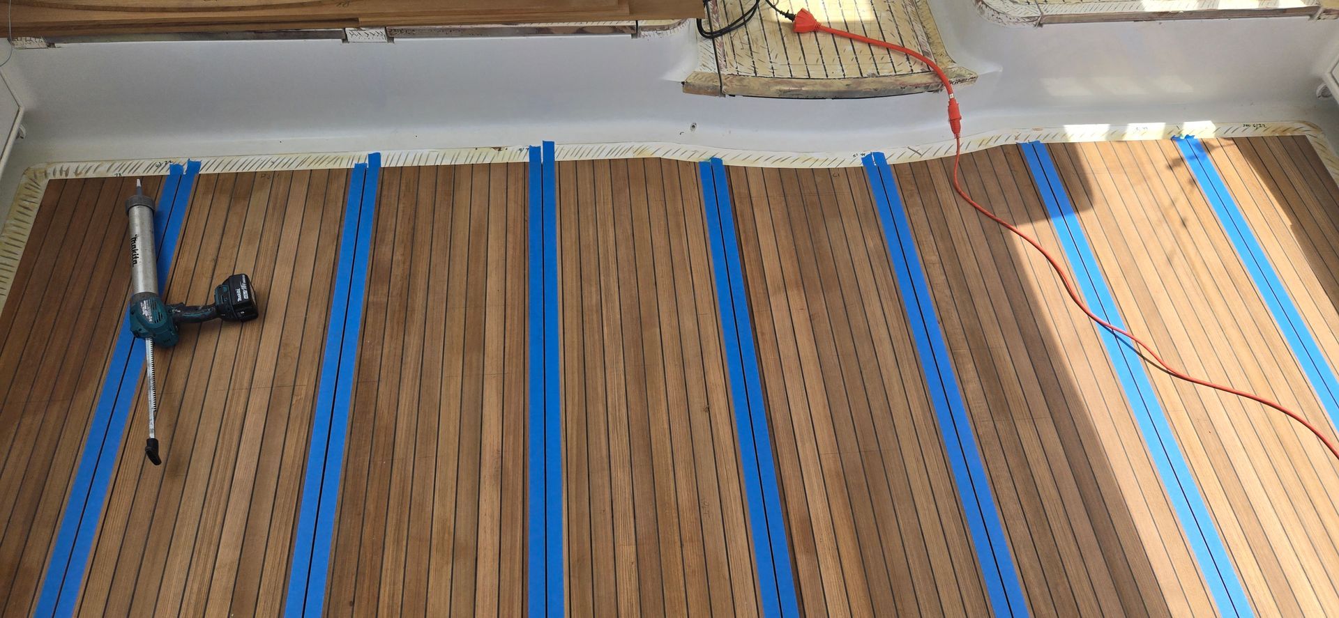 Teak deck with bond breaker tape applied