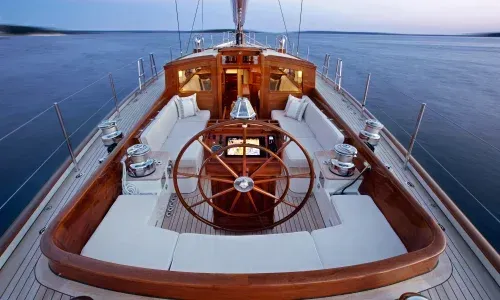 Teak helm by Teakdecking Systems, showcasing precision craftsmanship and elegant design for a luxurious marine setting