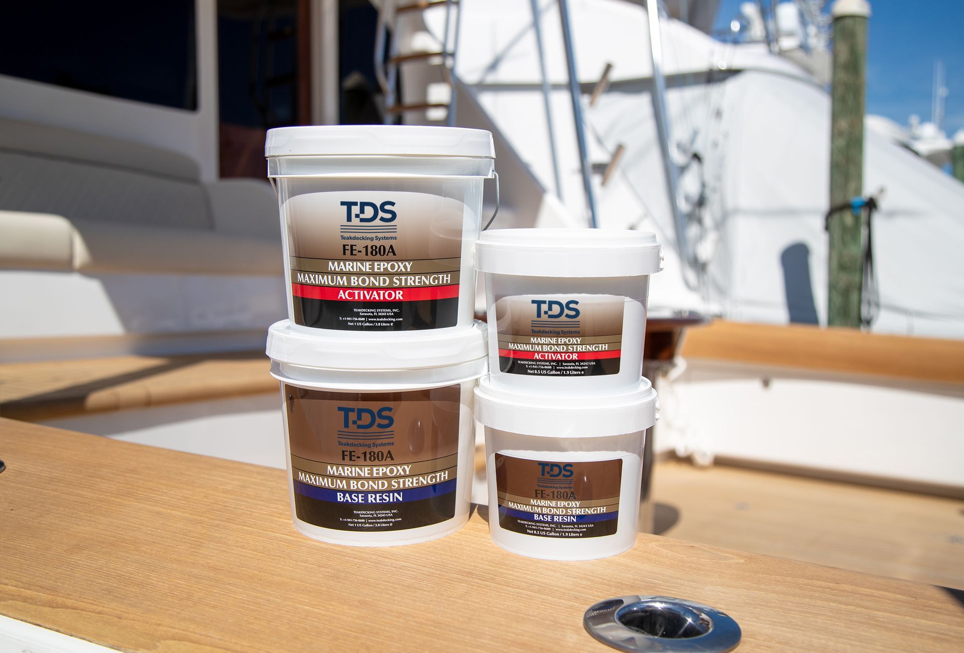 Assorted Teakdecking Systems products displayed, including cleaners, caulking, and fairing compounds, ready for use