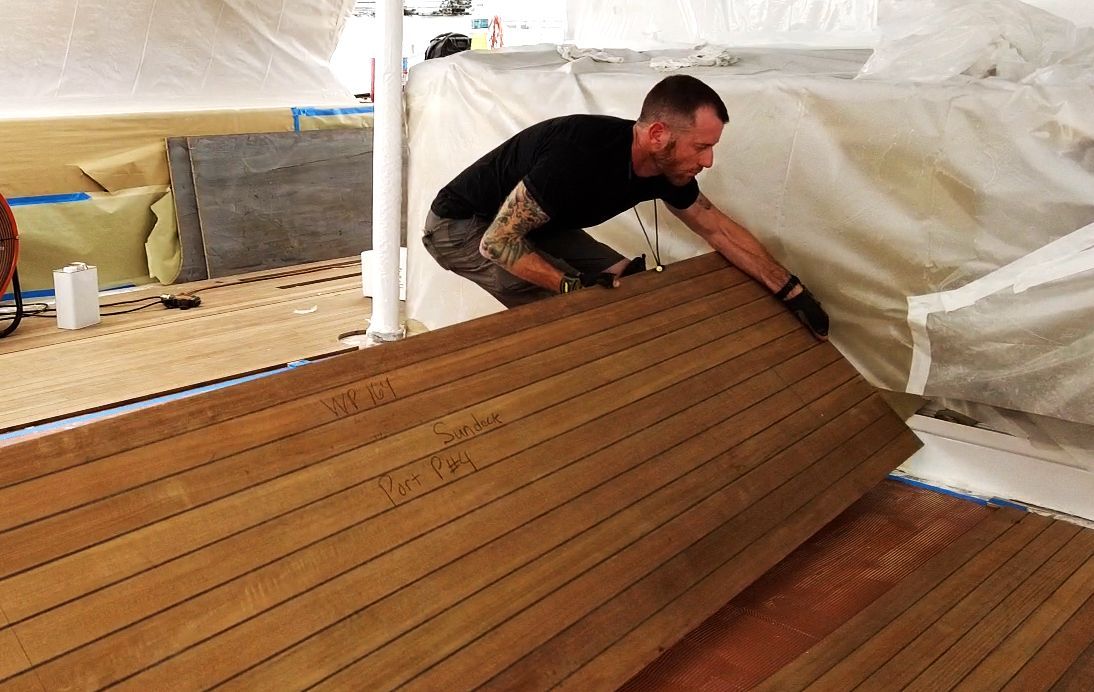 TDS worker expertly laying a deck on a yacht, highlighting the craftsmanship and career opportunities at Teakdecking Systems