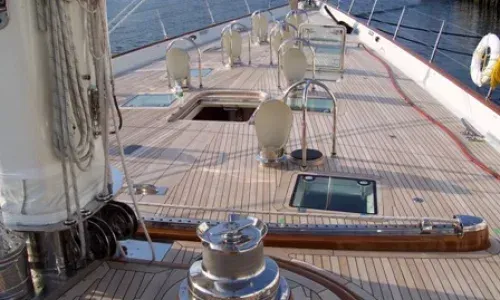 Beautiful teak deck by Teakdecking Systems, featuring the bow of a boat with deck hatches, showcasing craftsmanship