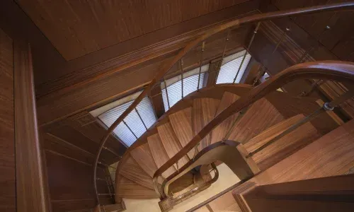 Beautiful teak interior staircase, showcasing elegant design and craftsmanship in a luxurious setting