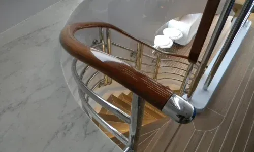 Close-up of Teakdecking Systems' high-gloss custom teak railing for the interior, uniquely crafted for each yacht