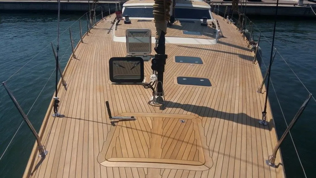 Wide view of a well-maintained teak yacht deck with clean planking, uniform seams, and preserved surface finish, demonstrating the long-term results of professional teak deck maintenance.