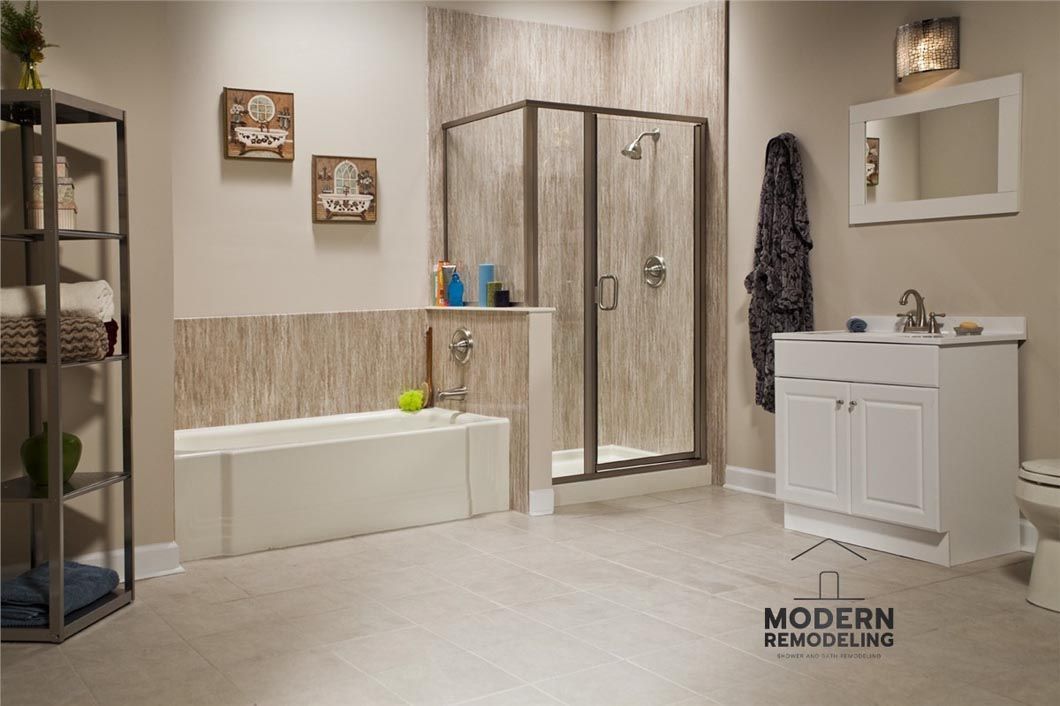 A bathroom with a tub , sink , mirror and shower.