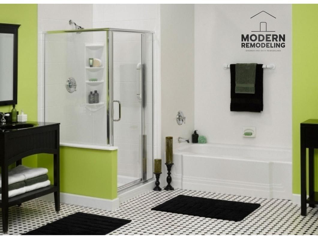 A bathroom with green and white walls and a modern remodel logo on the wall
