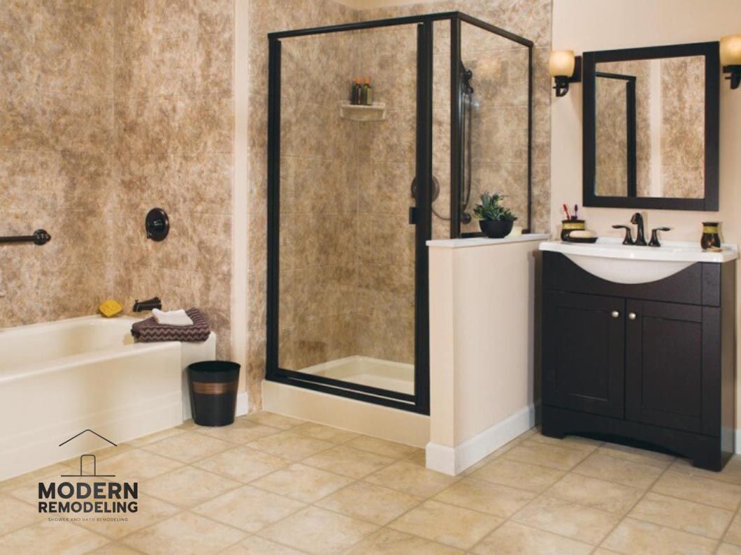 A bathroom with a walk in shower and a sink