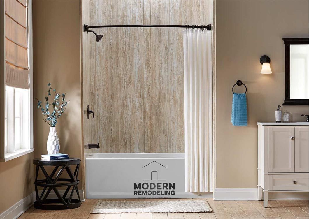 A bathroom with a bathtub , sink , mirror and shower curtain.