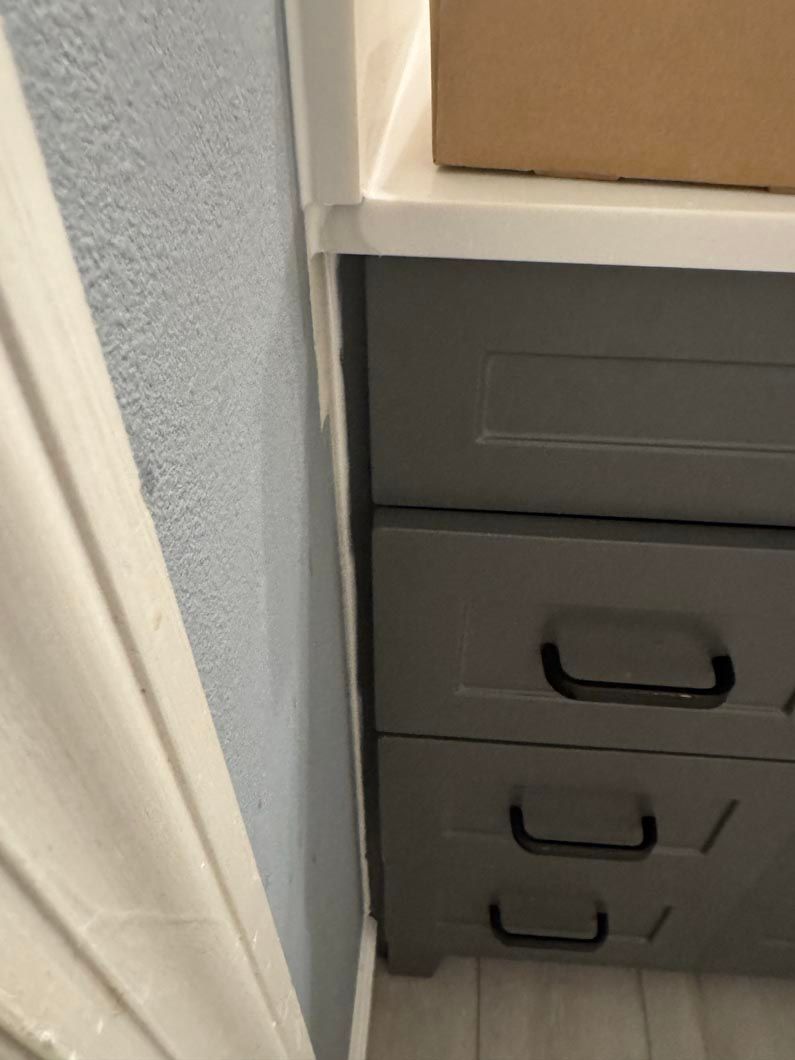 A dresser with three drawers and a box on top of it.