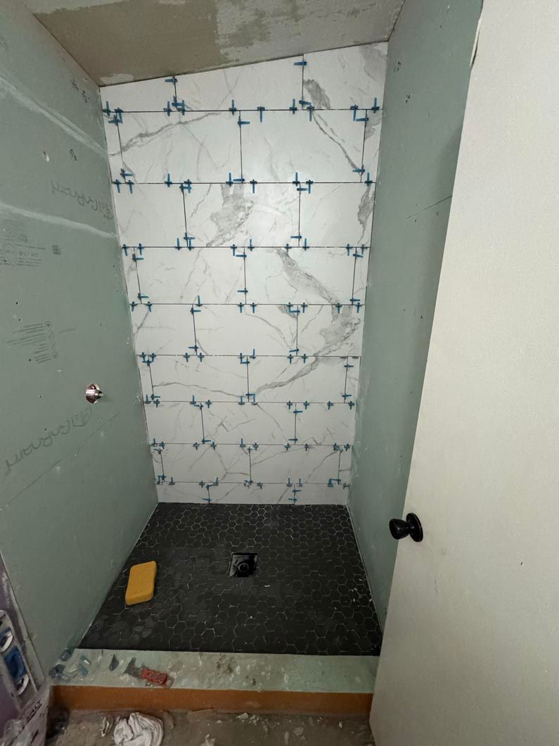 A shower stall is being built in a bathroom.