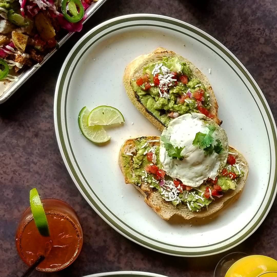 A white plate topped with guacamole and ice cream.