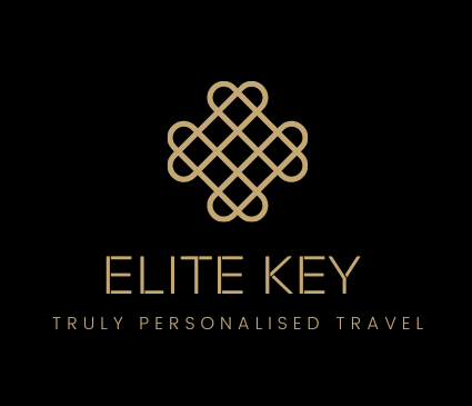 Gold logo for Elite Key travel company: intertwined heart-shaped design above text on black background.