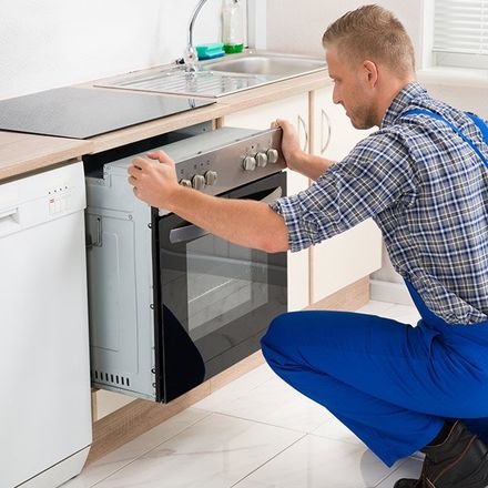 Appliance Repair — Man Repairing Oven in Bradenton, FL