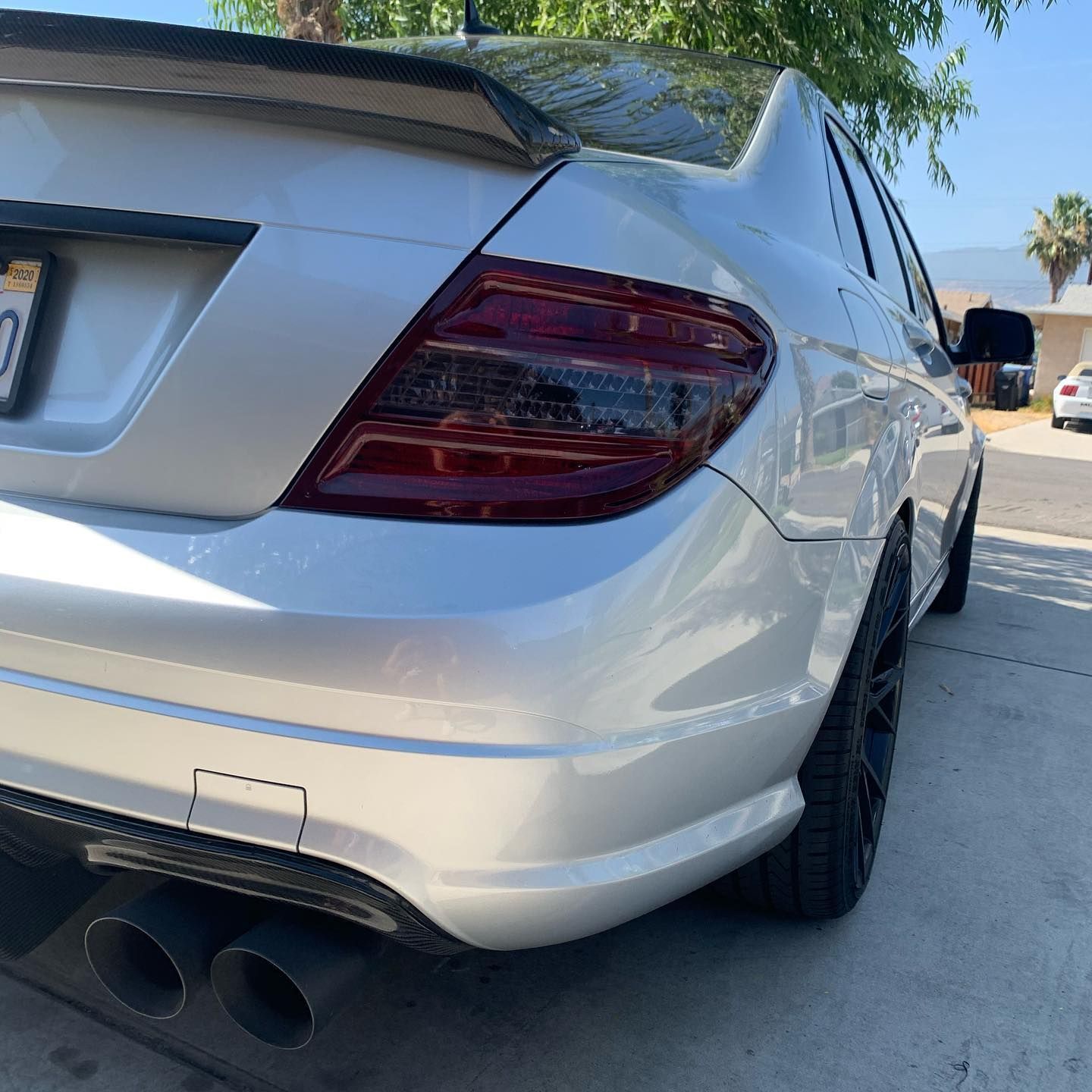 A silver car is parked on the side of the road