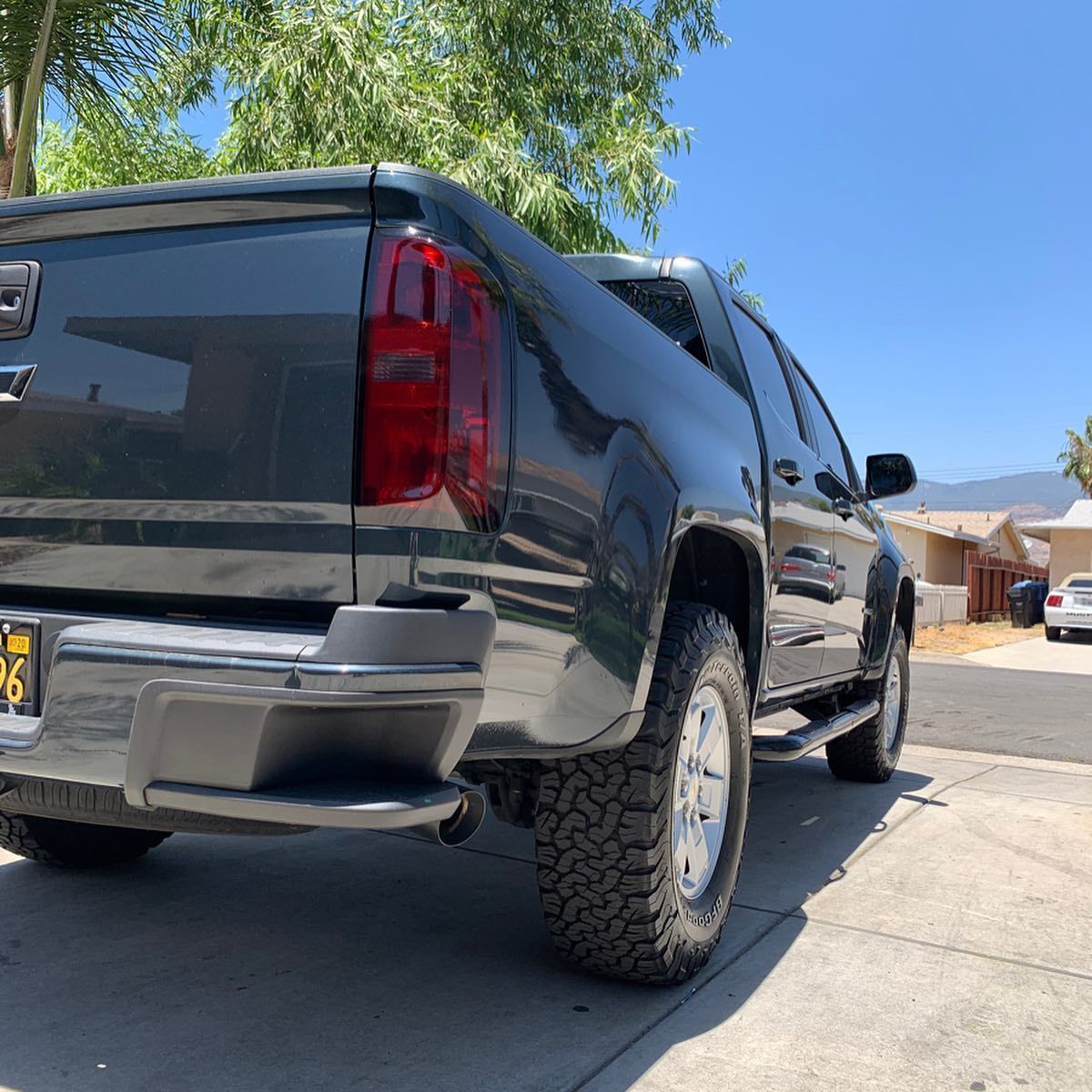 A black truck is parked on the side of the road