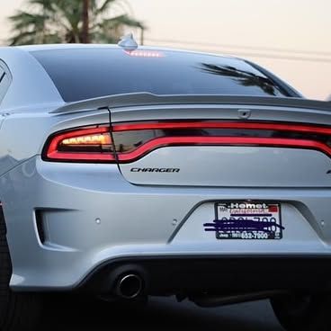 A silver dodge charger with a license plate that says hemet