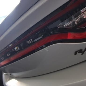 A close up of the tail light of a white dodge charger.