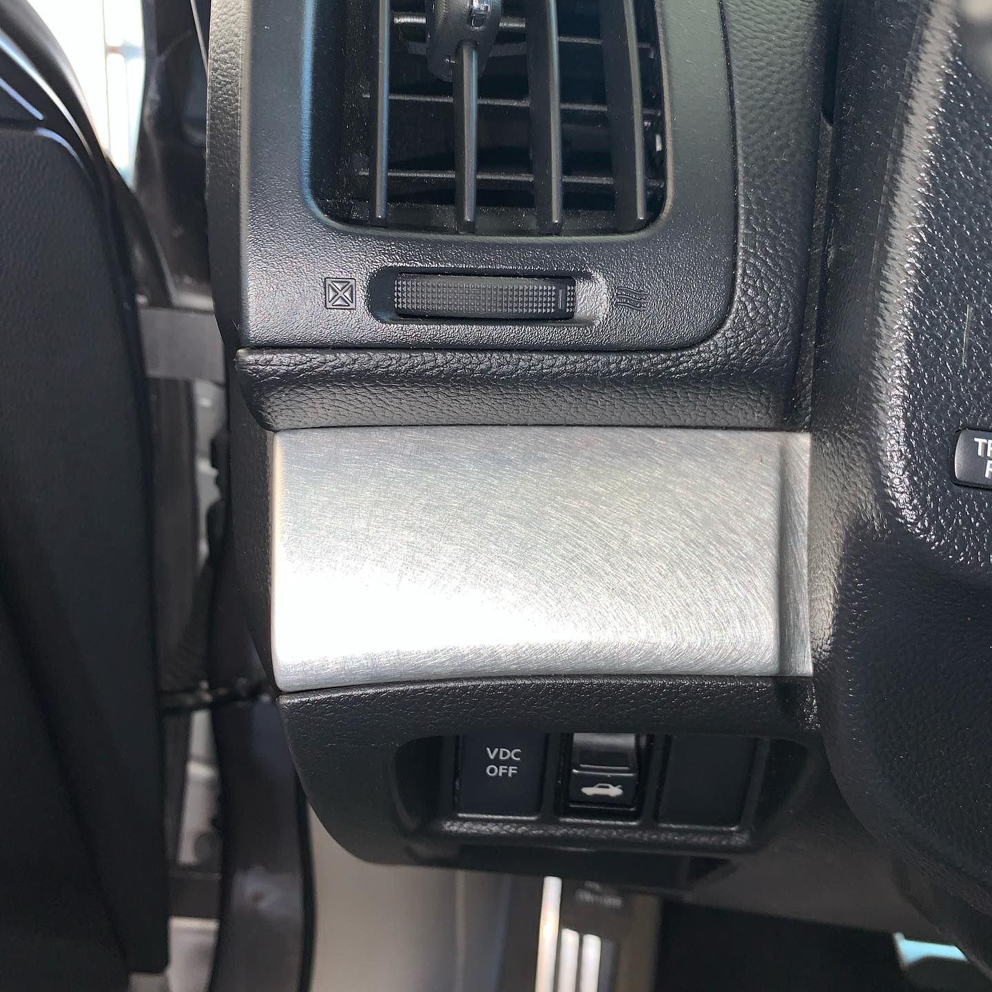 A close up of a car dashboard with a button that says esc