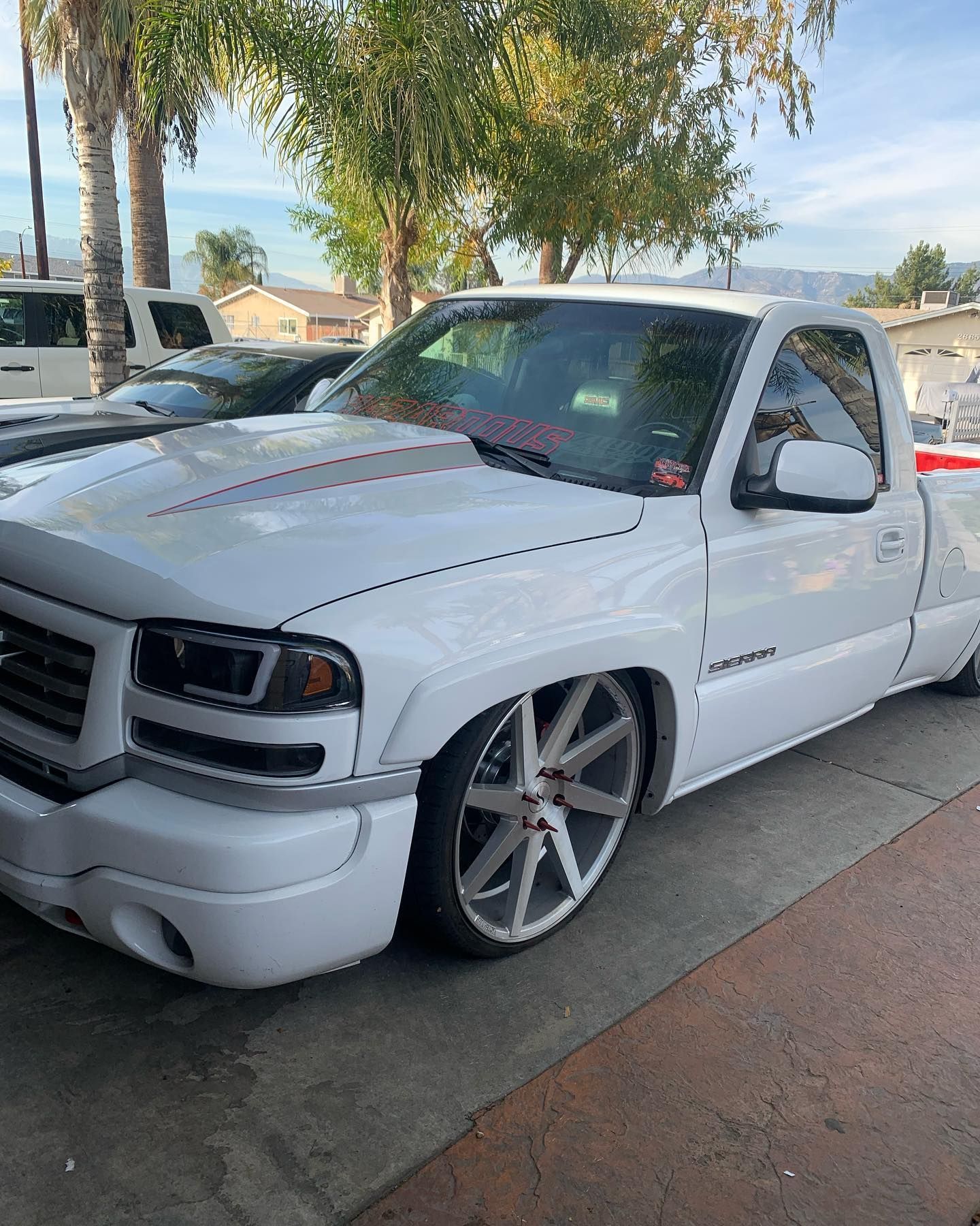 A white truck is parked on the side of the road.