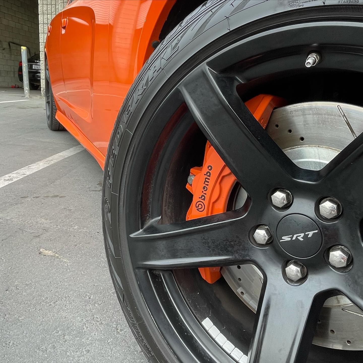 A close up of a car wheel that says srt on it