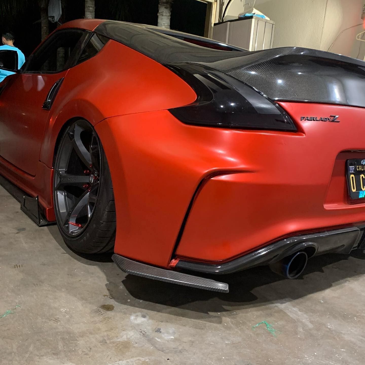 A red car with a license plate that says 00