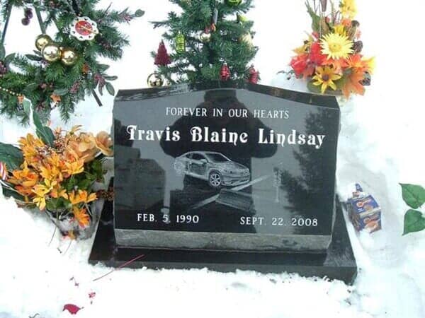Black headstone with inscription 