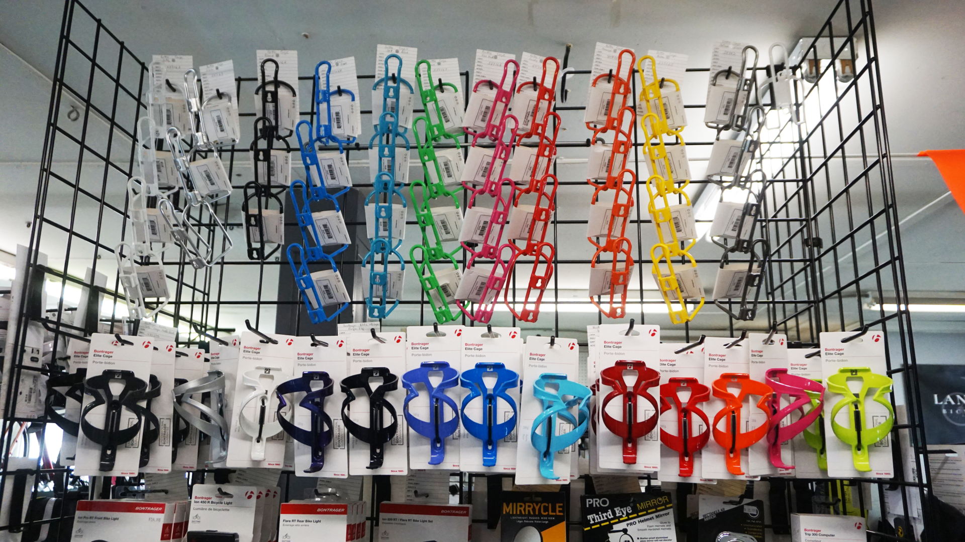 A bunch of sunglasses are hanging on a rack in a store