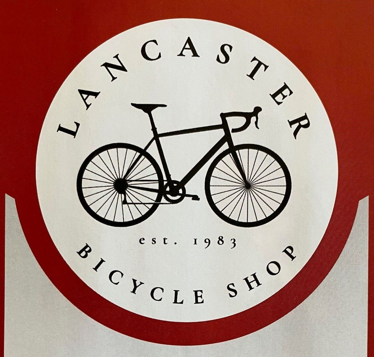 A lancaster bicycle shop logo with a bicycle on it