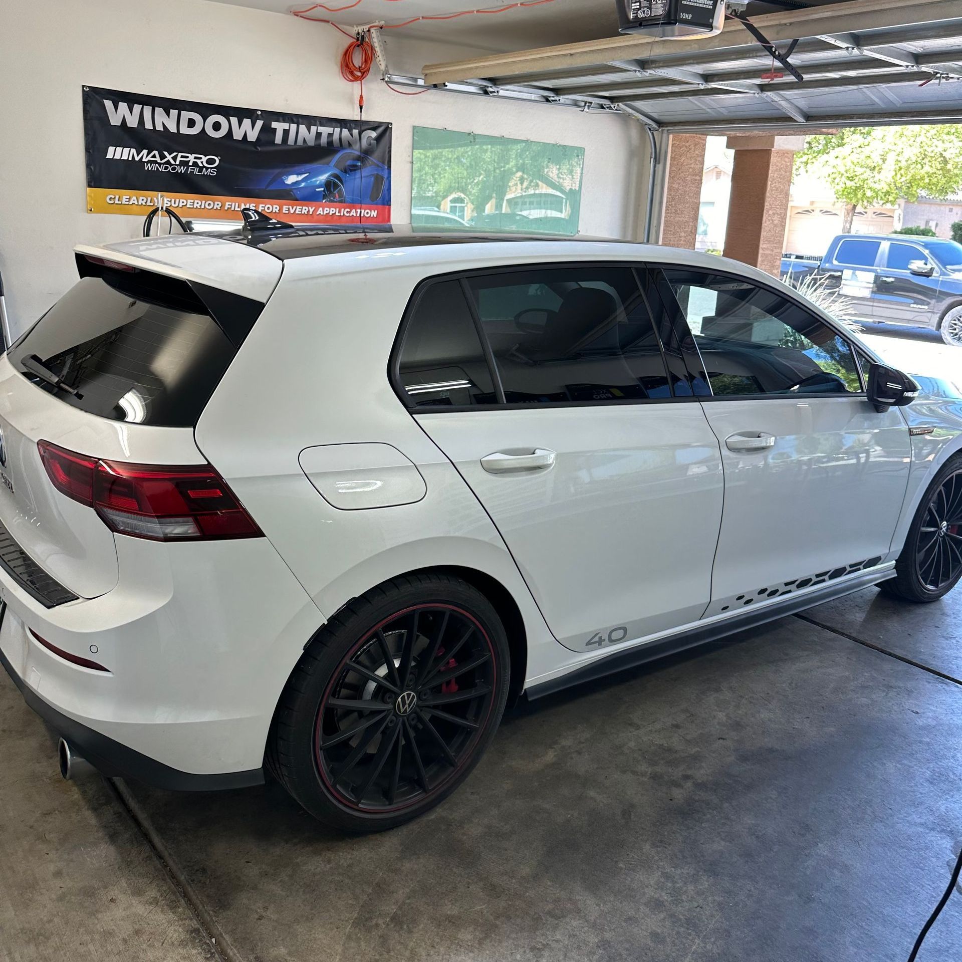 A newly tinted VW Golf in a tint shop.