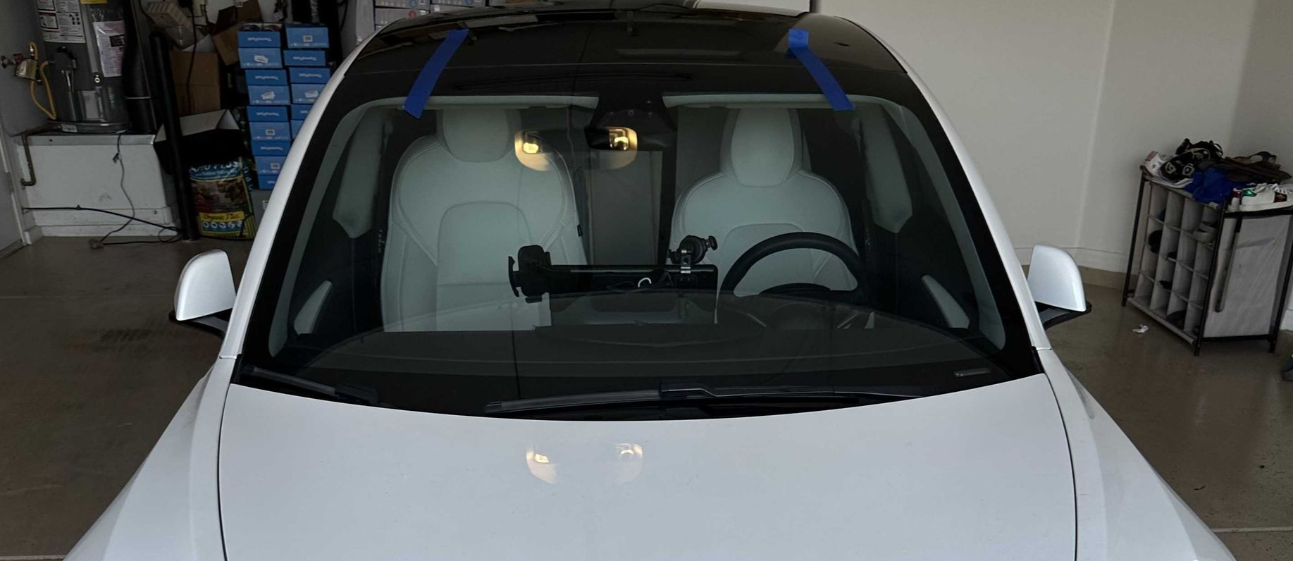 Windshield replaced on a white Tesla Model Y parked in a garage in Gilbert, AZ.