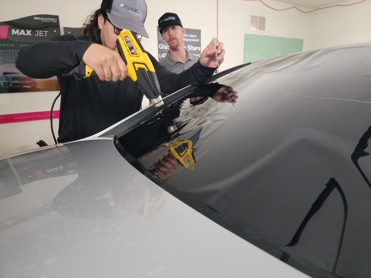 Window tinting process of shrinking the film to fit the back glass of the vehicle.
