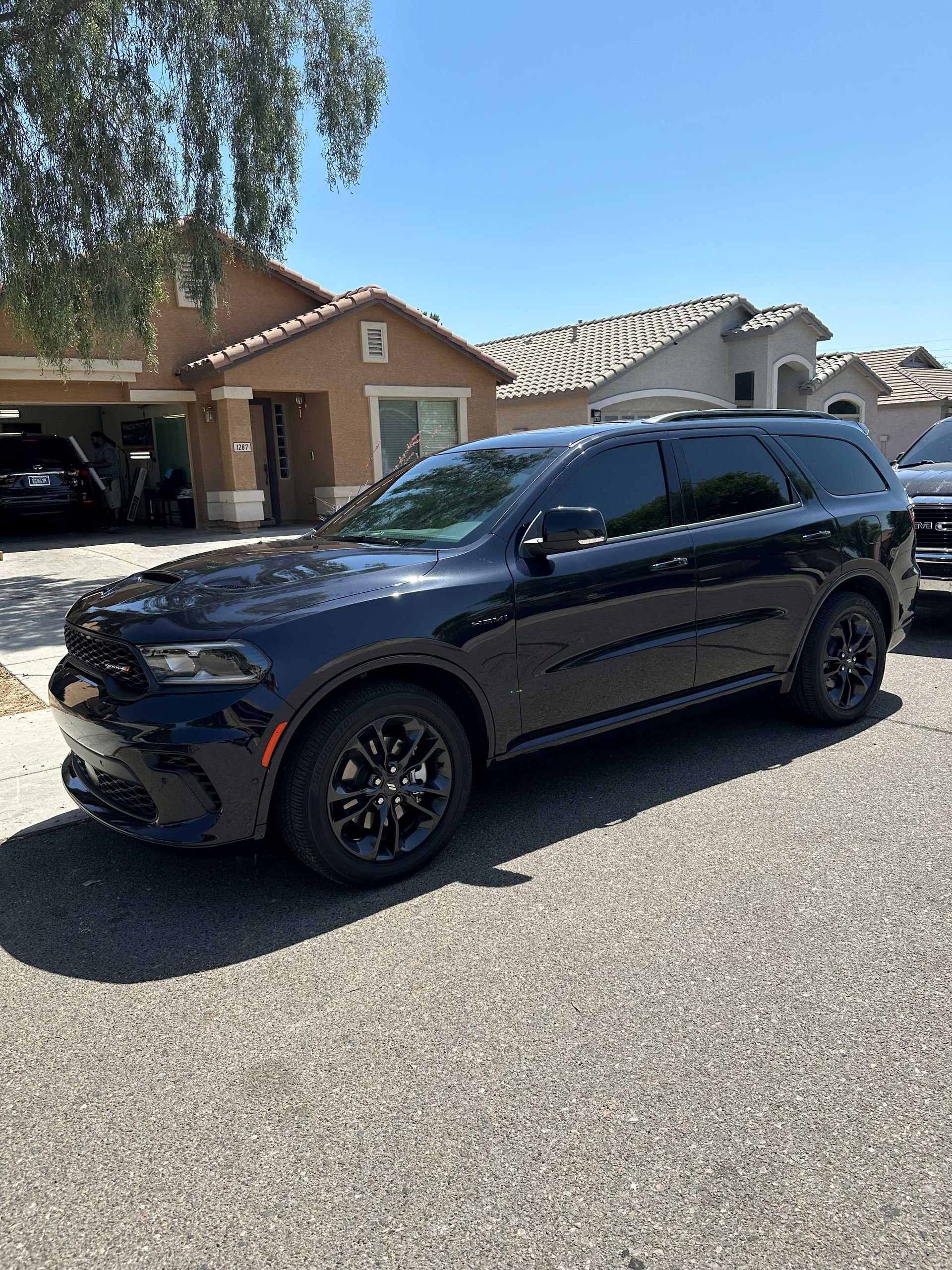Dodge SUV with its windows tinted with dark ceramic film.