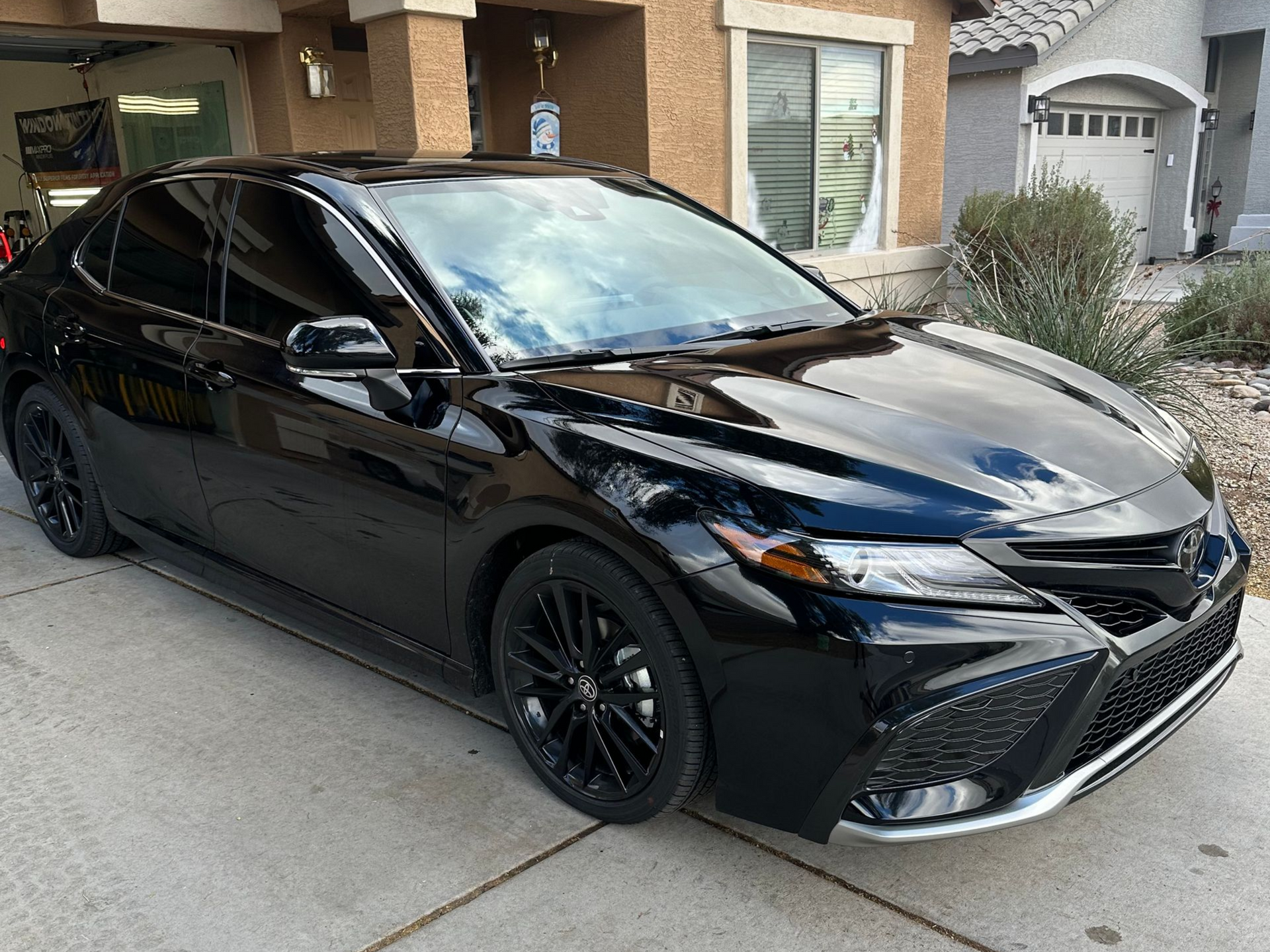 Black Toyota car with dark limo tint on all the windows after window tinting service.