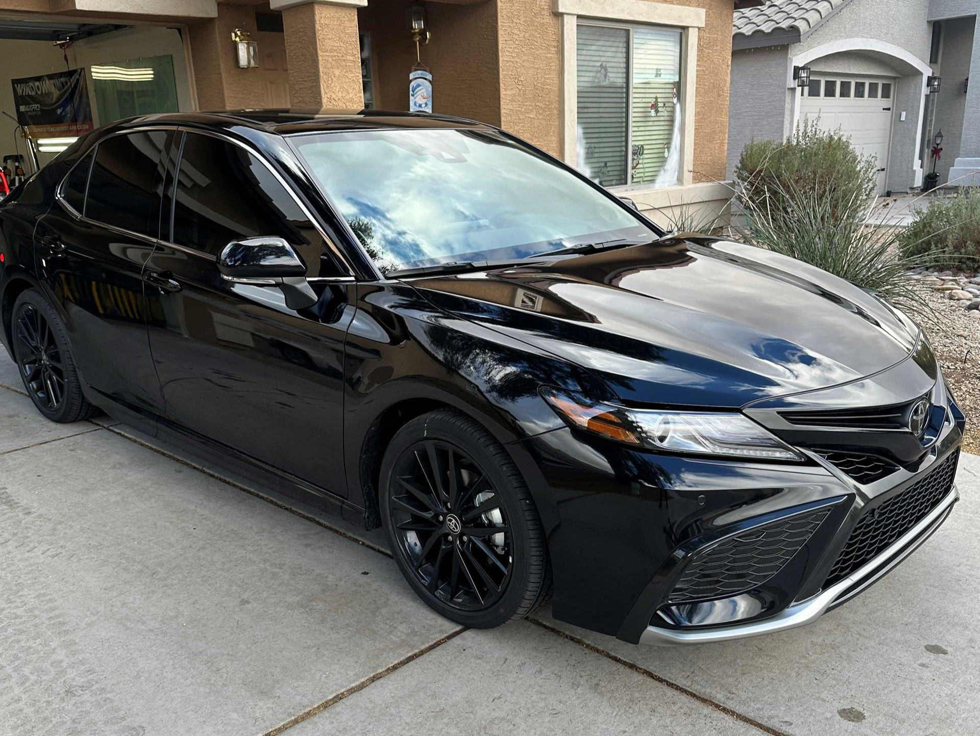 Black Toyota with dark ceramic tint on the windows.